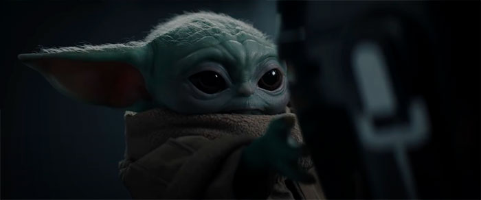 Baby yoda holding his hand forward