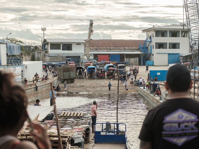 Moto taxis and trucks wait to pick up the passengers and cargo as our boat arrives at the port of Iquitos Moto taxis and trucks wait to pick up the passengers and cargo as our boat arrives at the port of Iquitos