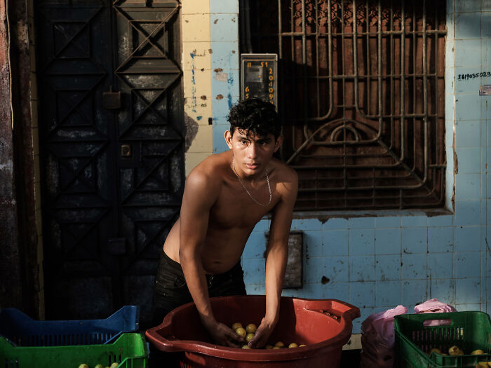 Street seller washes limes in Belen market, Iquitos Street seller washes limes in Belen market, Iquitos