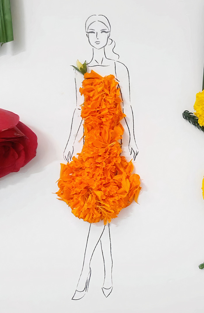 A drawing of a woman dressed in real flower petal gown