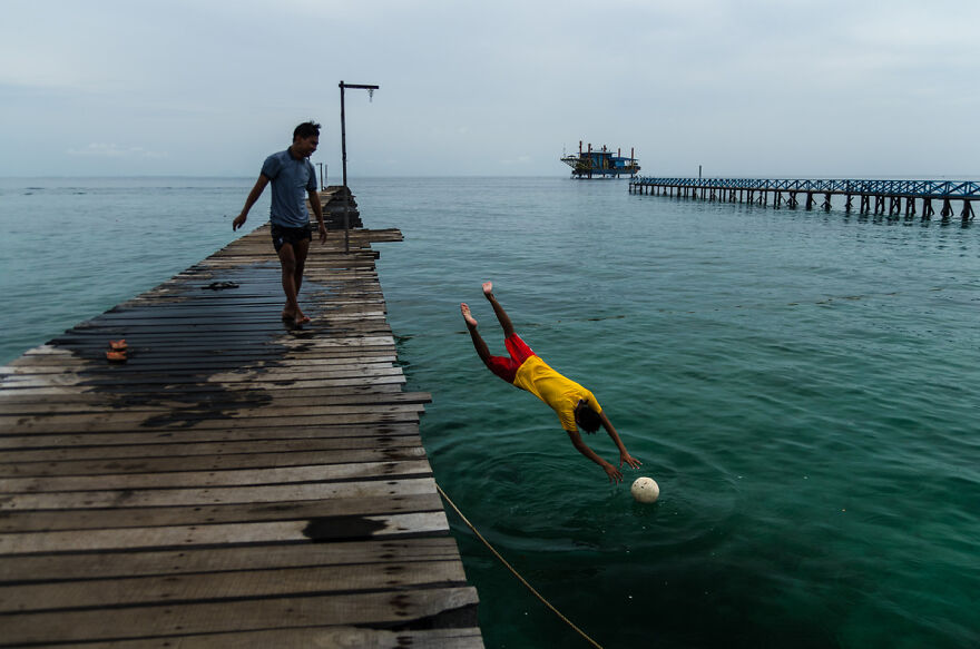 Boys of the Bajau Laut tribe playing futball