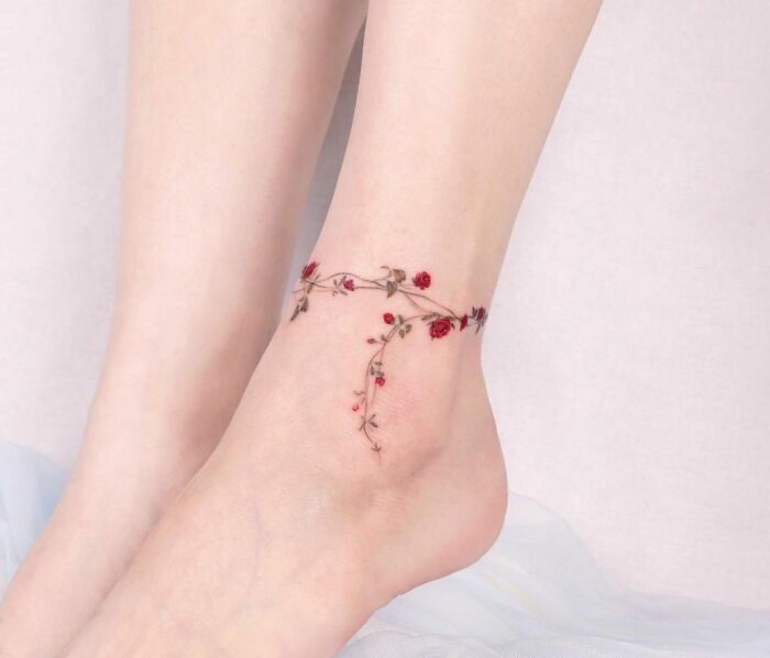Delicate ankle tattoo featuring a floral vine design, showcasing tattoo care and inspiration.