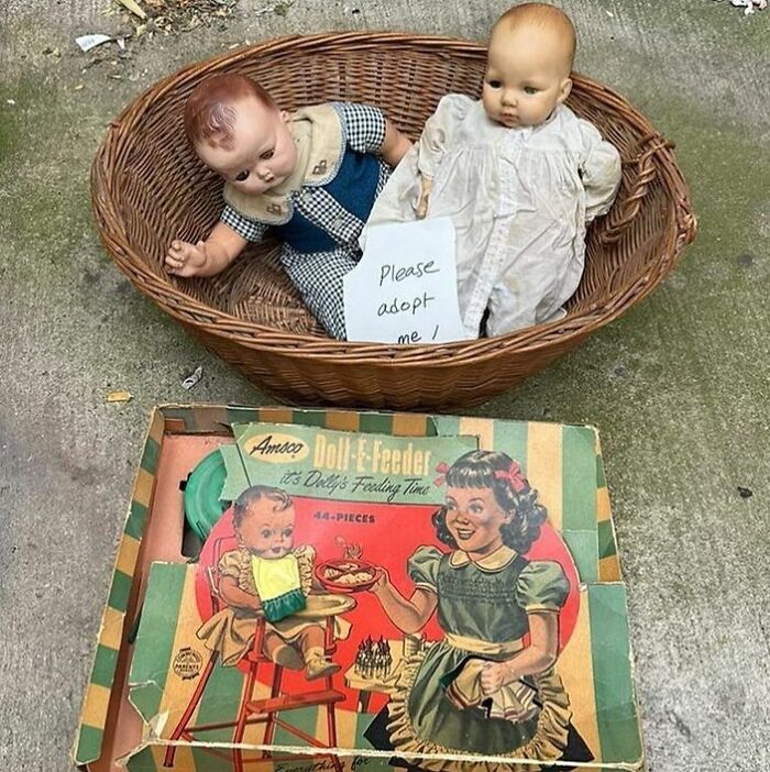 Two vintage dolls in a basket and a retro doll feeder toy box, examples of thrown out treasures in NYC.