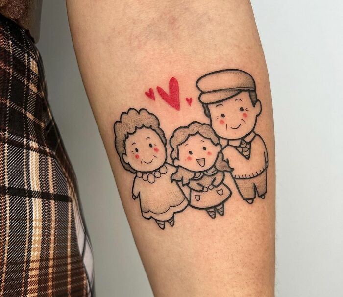 Family memorial tattoo featuring cartoon-style grandparents and child with hearts.