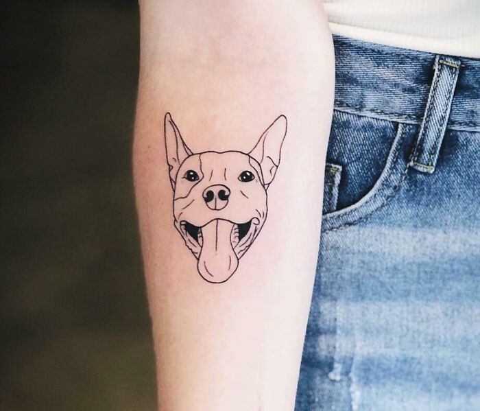 Dog tattoo on forearm, a memorial design to honor family.