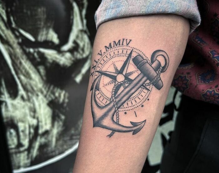 Anchor tattoo with compass and Roman numerals, symbolizing family and memorial themes.