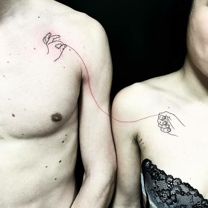 Minimalist family tattoos on two people, connected by a red string, symbolizing unbreakable bonds.