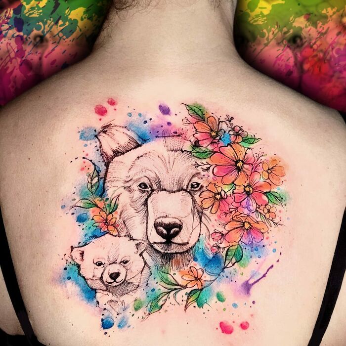 Colorful family-themed tattoo with bears and flowers on back, symbolizing unbreakable bonds.