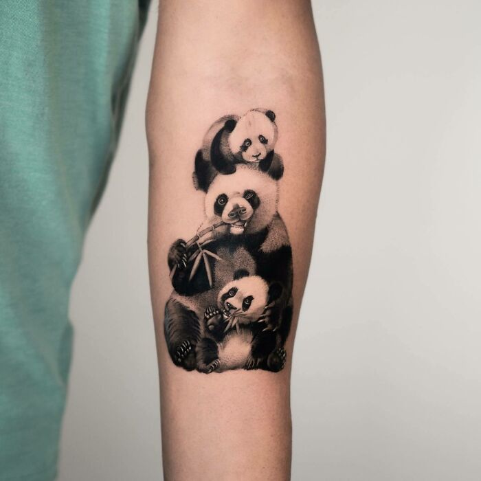 Panda family tattoo on forearm, symbolizing unbreakable family bonds and connection.