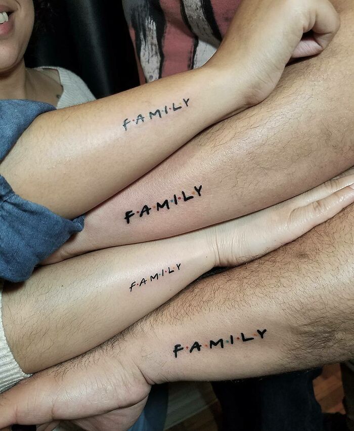 Several arms with matching "Family" tattoos symbolizing unbreakable bonds.