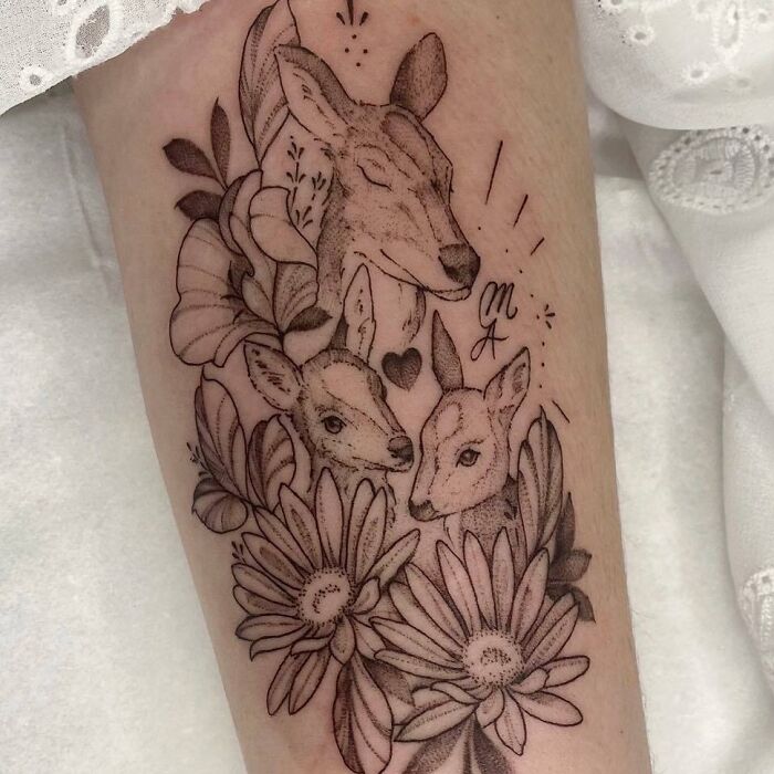 Floral deer family tattoo with three deer and daisies, symbolizing unbreakable bonds.