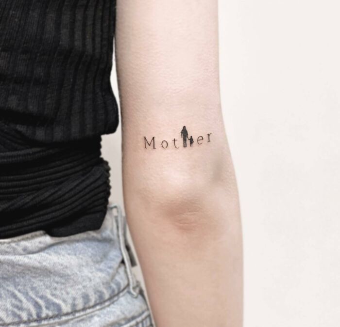 Tattoo on arm reading "Mother" symbolizing family bonds with silhouette figures, expressing unbreakable connections.