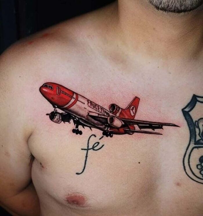 Tattoo of a red airplane on chest, symbolizing unbreakable family bonds.