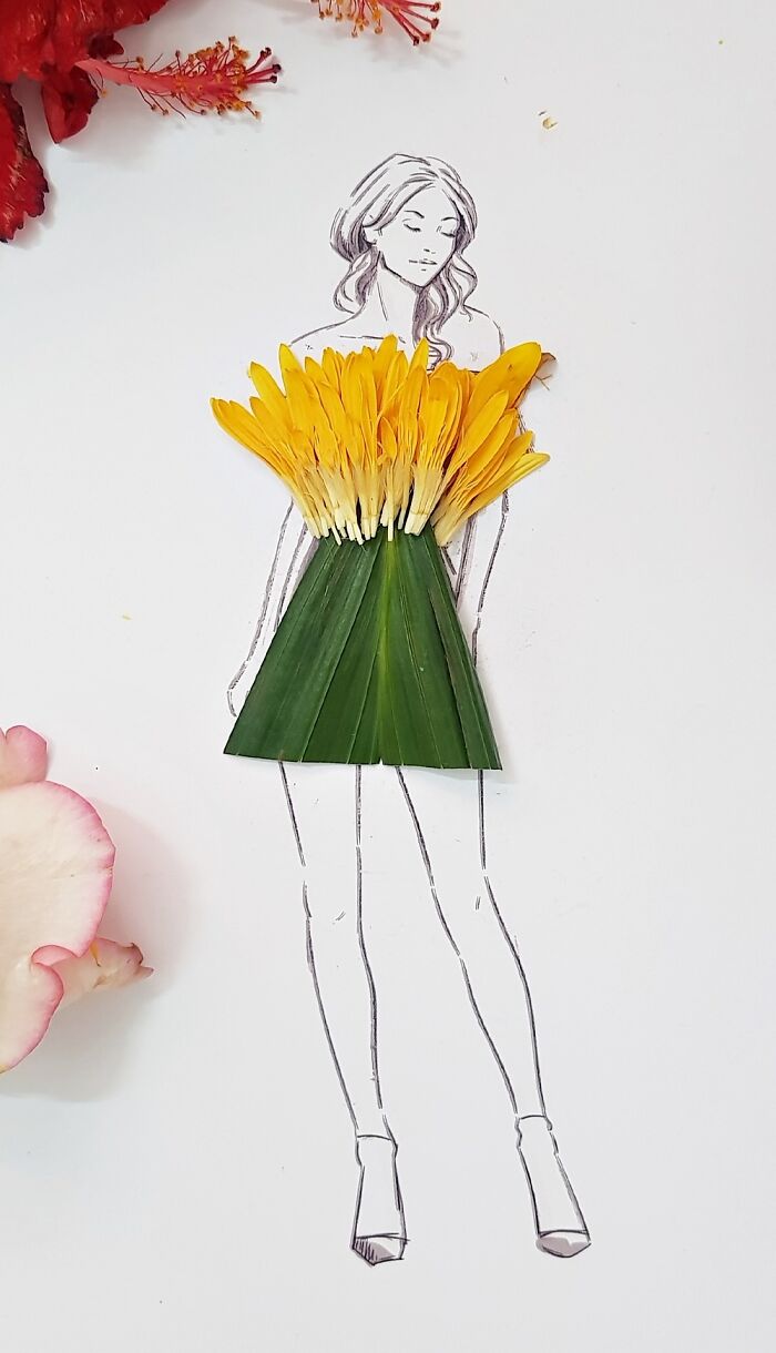 A drawing of a woman dressed in real flower petal gown