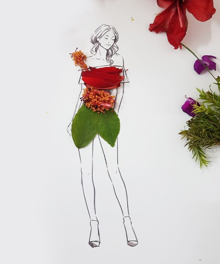 A drawing of a woman dressed in real flower petal gown