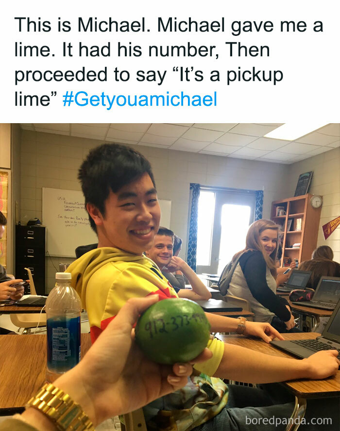 Person smiling in a classroom holding a lime with a phone number, referencing a humorous pickup line.