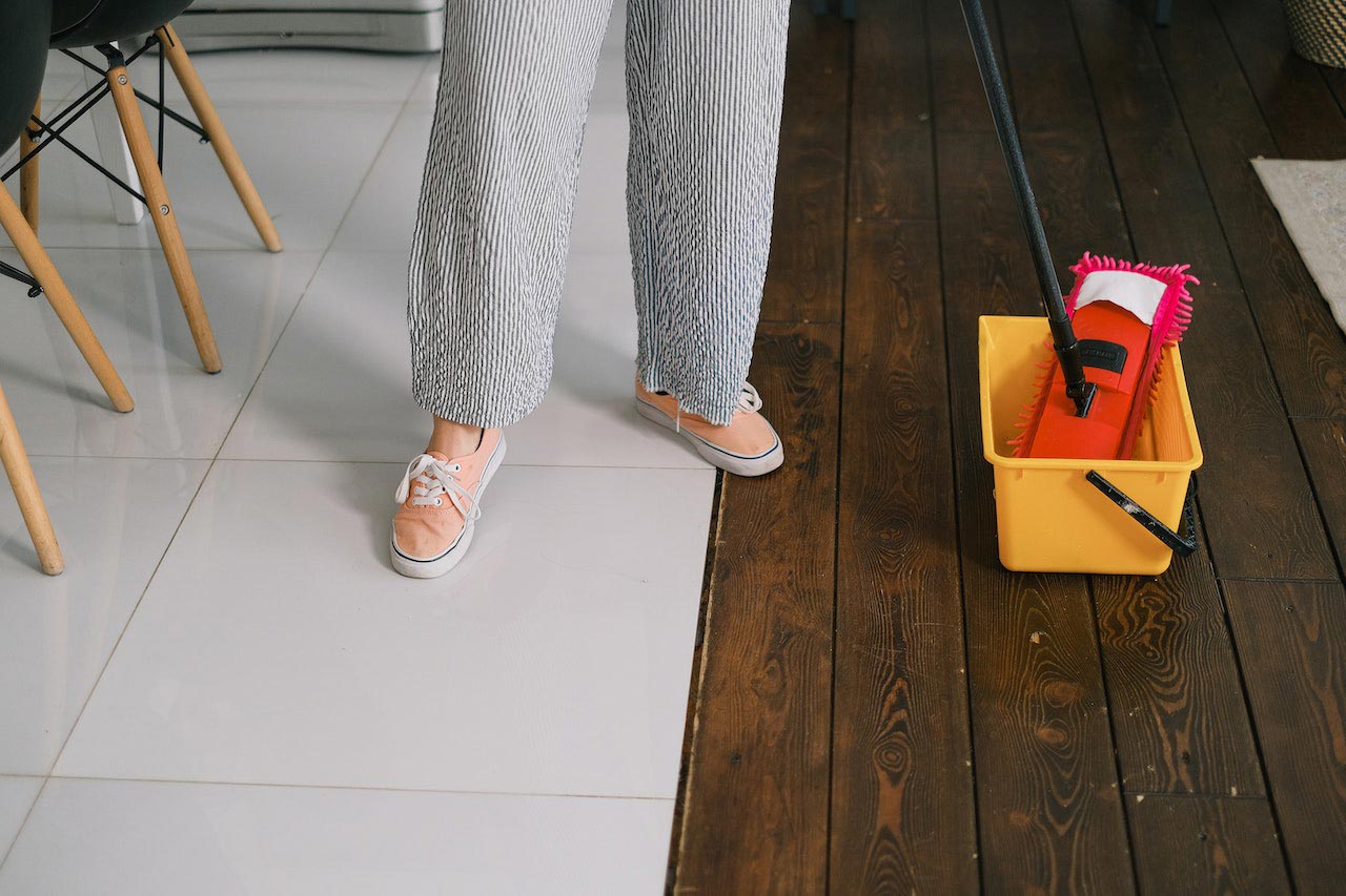 A woman is preparing to wash the floor at home