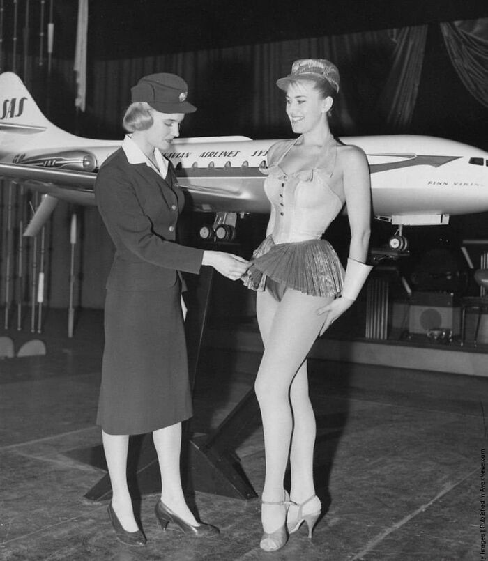 A Stewardess Examines A New Uniform Proposal For Scandinavian Airlines. It Was Not Approved. 1964