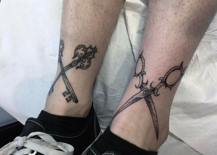 Ankle tattoos of a decorative key and vintage scissors on legs, showcasing tattoo care and design inspiration.