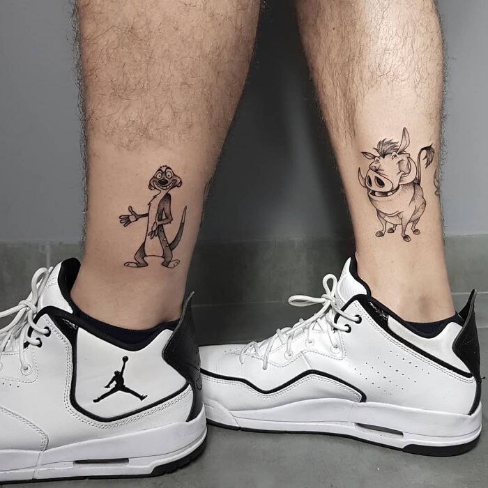Ankle tattoos featuring cartoon characters with white sneakers on a gray background.