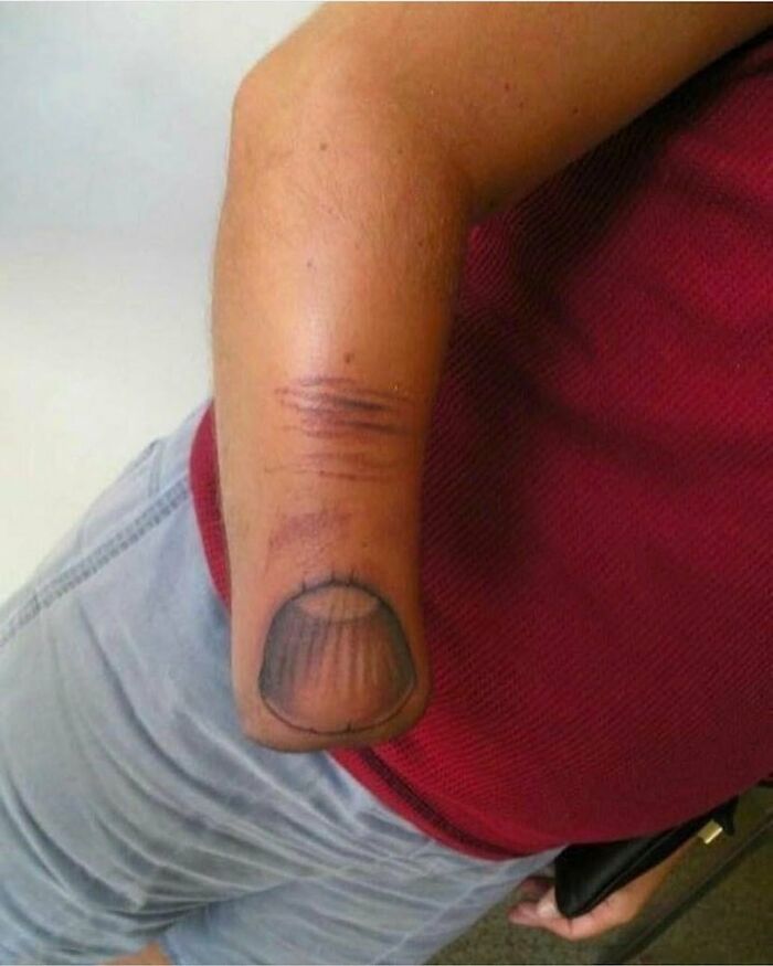 Tattoo failure showing a finger drawn on a person's arm, illustrating an epic ink lesson.