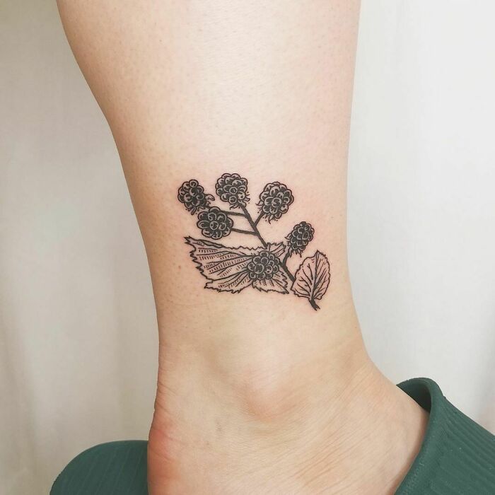 Blackberry ankle tattoo design, showcasing intricate details and vibrant style.