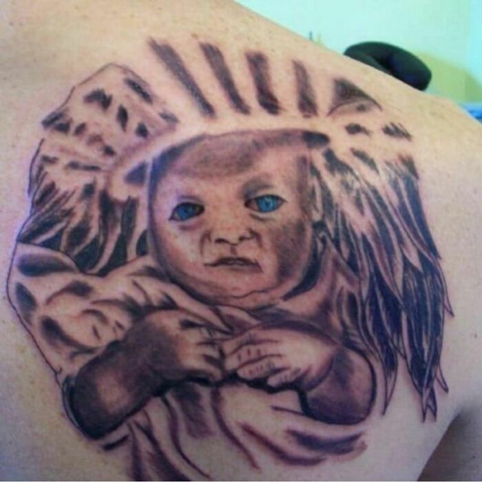 Tattoo depicting a baby with wings, exhibiting an unusual art style.