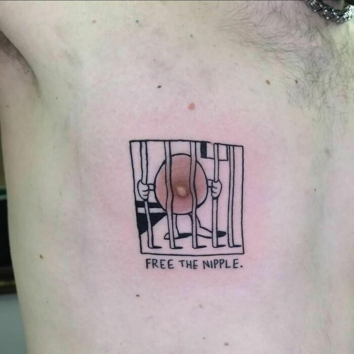 Tattoo of a n****e behind bars with text "Free the N****e," symbolizing a humorous lesson in ink.