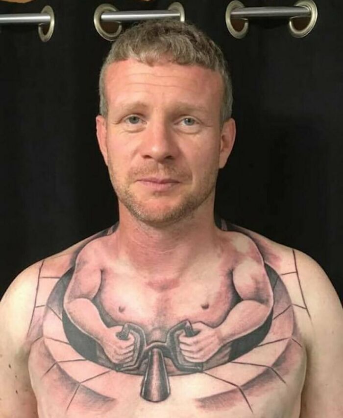 A man with a unique tattoo design covering his chest, showcasing an epic failure turned into a lesson in ink.