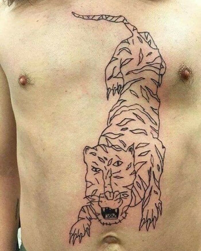 Tattoo showing a tiger drawing on a chest, illustrating tattoo failures with humorous results.