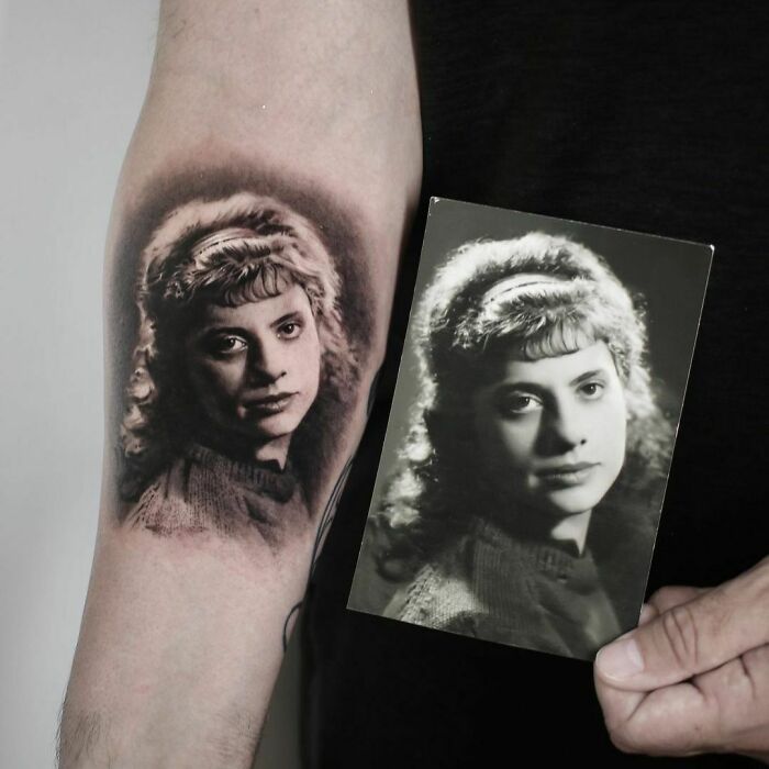 Tattoo of a woman on an arm beside a black-and-white photo, honoring family.