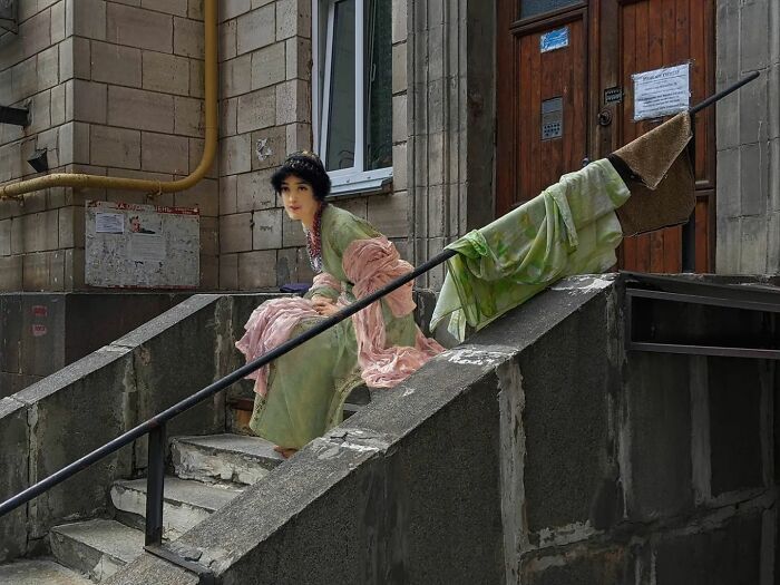 An image of a woman from "Watching And Waiting" painting in modern surroundings