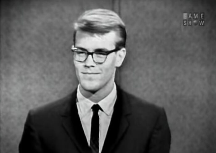 Randy Gardner, sleep-deprivation record-holder, wearing glasses and a suit on a vintage game show for useless facts.