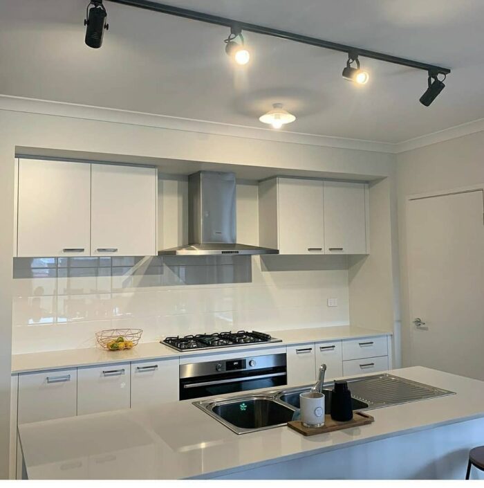 White kitchen with track lighting White kitchen with track lighting