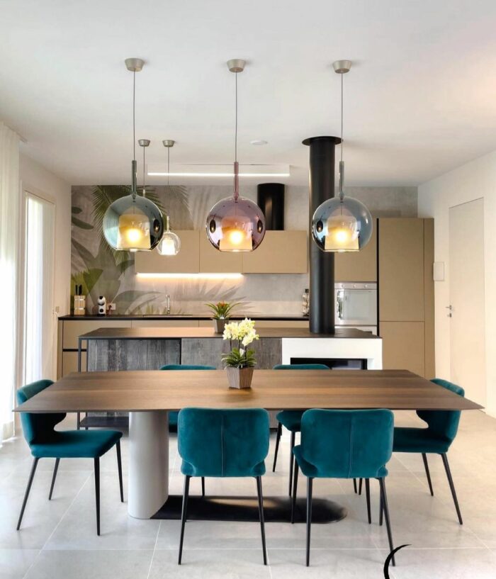 Kitchen with wooden table chairs and glass pendant with shades Kitchen with wooden table chairs and glass pendant with shades