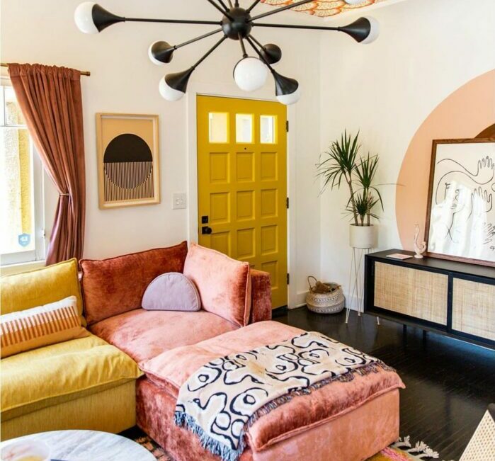 a maximalist living room with a pink and yellow sofa and orange wallpaper on the ceiling a maximalist living room with a pink and yellow sofa and orange wallpaper on the ceiling