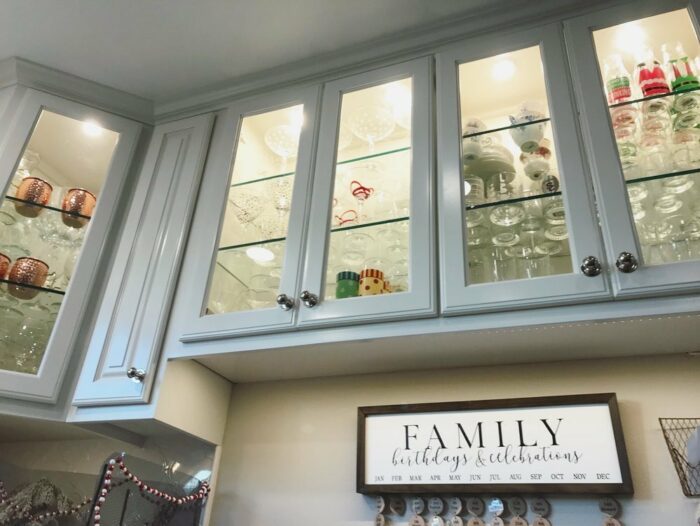 Kitchen cupboards with puck lights and dishes Kitchen cupboards with puck lights and dishes