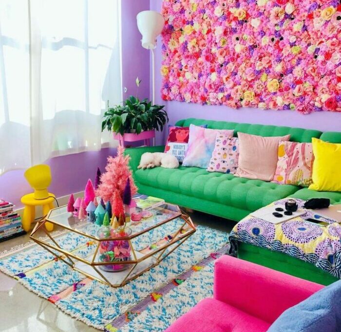 a maximalist living room with a flower wall, a green sofa, and many colorful items a maximalist living room with a flower wall, a green sofa, and many colorful items