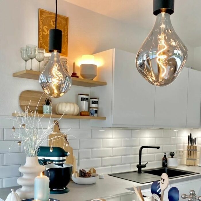 Kitchen with white cupboards and Edison bulbs Kitchen with white cupboards and Edison bulbs