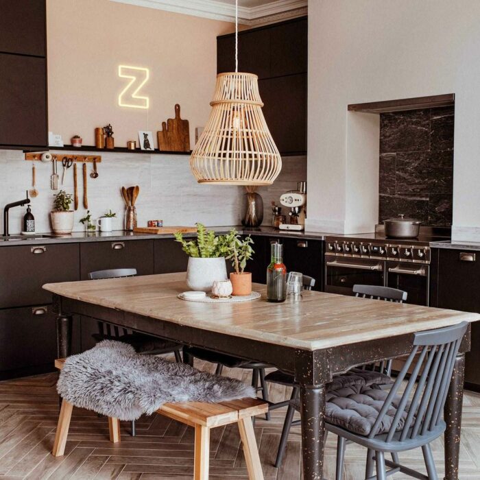 Brown kitchen with table and chairs and neon sign on the wall Brown kitchen with table and chairs and neon sign on the wall