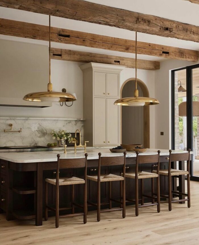 Kitchen with golden long pendants and marble wooden table with chairs Kitchen with golden long pendants and marble wooden table with chairs