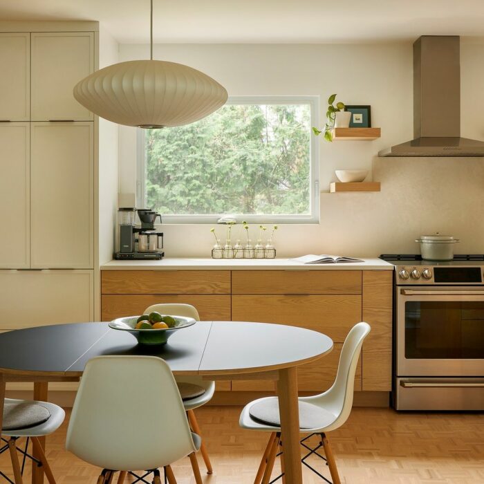 White brown kitchen with wooden table chairs and saucer lights White brown kitchen with wooden table chairs and saucer lights