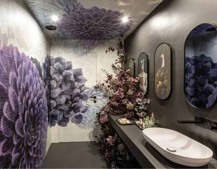 Bathroom with trendy purple floral textured wallpaper and modern sink cabinet showcasing elegant bathroom wallpaper ideas.