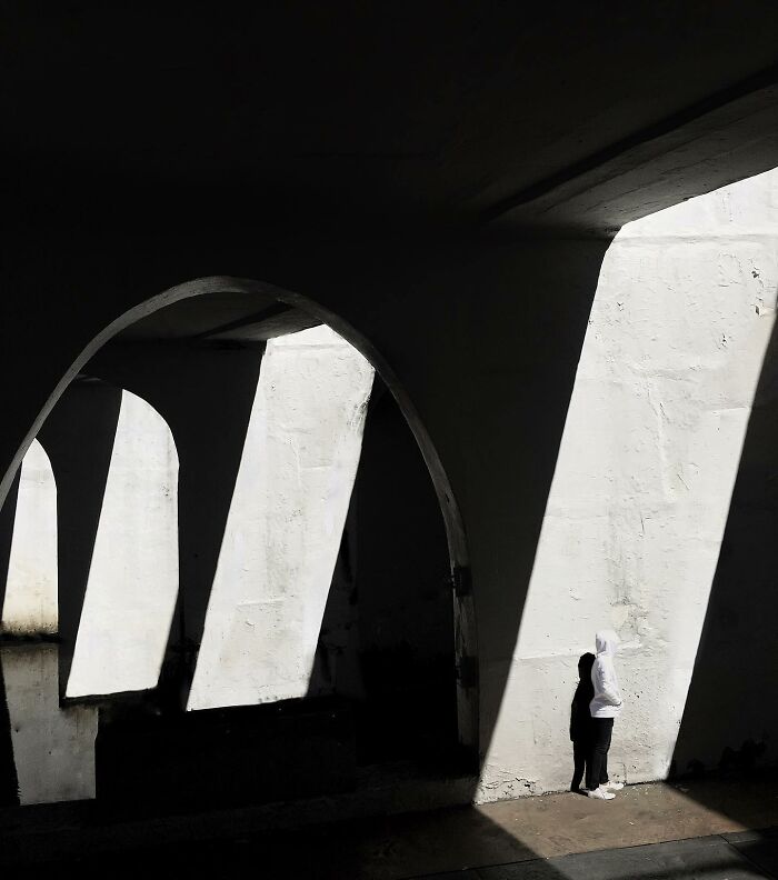 A photograph of a guy in a hoodie