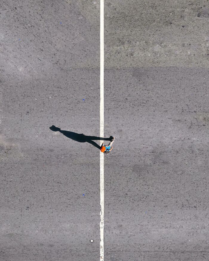 A photograph of a person walking along the line