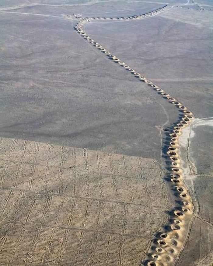 The Persian Qanat, Also Known As Qanats, Represent An Astonishing Feat Of Engineering That Dates Back 3,000 Years. These Remarkable Systems Are Found In Desert Regions Of Iran And Continue To Be Utilized Today. Originating During The Iron Age, The Process Of Constructing Qanats Involved Skilled Surveyors Identifying Elevated Water Sources, Often Located At The Head Of Former River Valleys Or Even Within Cave Lakes. Subsequently, They Meticulously Carved Lengthy, Sloping Tunnels From These Water Sources To The Areas Where Water Was Needed. The Visible Openings Seen Above Ground Are Carefully Crafted Air Shafts, Designed To Release Dust And Provide Much-Needed Oxygen For The Workers Who Tirelessly Dug The Qanats By Hand, Sometimes Spanning Distances Of Up To Forty Miles. Eventually, These Tunnels Emerge At Ground Level, Transforming Into Captivating Oases. The Construction Of Qanats Demanded Painstaking Effort, Requiring Immense Precision. The Slope Of The Tunnels Had To Be Precisely Calculated To Allow Water To Flow Freely Without Stagnation. If The Slope Was Too Steep, The Force Of The Water Could Accelerate Erosion And Cause Tunnel Collapse. Even After Completion, Qanats Necessitate Annual Maintenance. However, The Irrigation Tunnels Played A Crucial Role In Enabling Agriculture To Thrive In The Arid Desert Regions. This Innovative Technology Gradually Spread Through Trade Along The Silk Road And The Expansion Of Muslim Conquests. As A Result, Qanats Can Be Found As Far Away As Morocco And Spain. The Persian Qanats Are A Testament To The Ingenuity And Enduring Legacy Of Ancient Engineering, Creating Fertile Landscapes In Inhospitable Terrains And Providing A Valuable Water Supply That Has Sustained Communities For Centuries