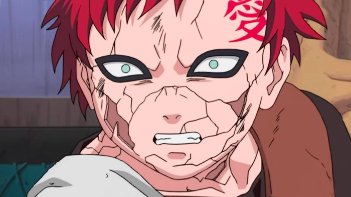 Gaara from anime showing sadness, with red hair and c*****d skin, representing themes of love, life, and loss.