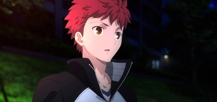 Red-haired anime character in a black and white jacket, standing outdoors at night.