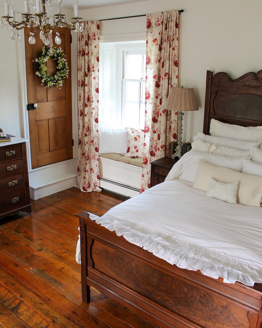 wooden bed near the window with floral curtains