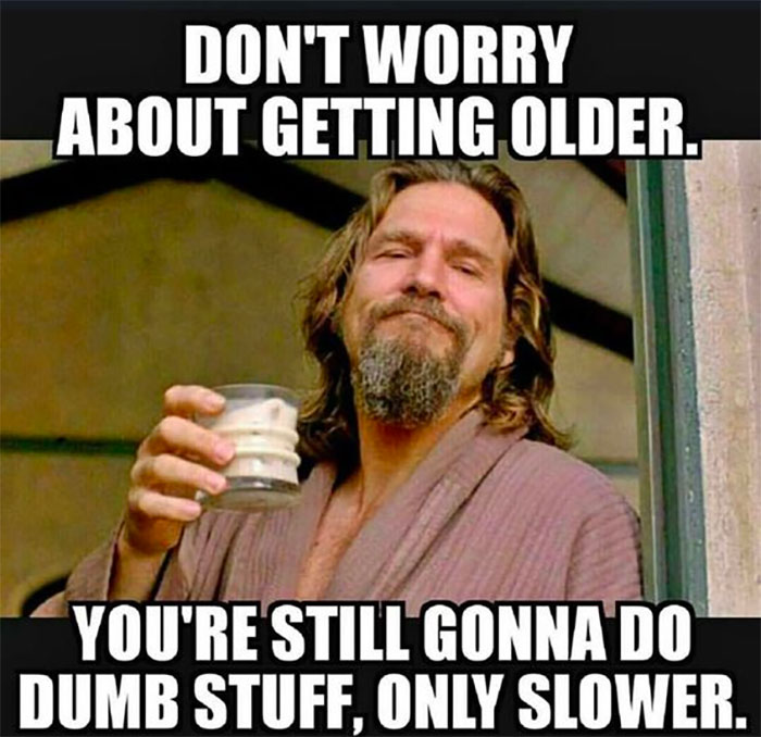Man in robe holding a drink with a funny birthday meme about getting older.